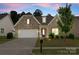 Charming home with a stone and brick facade, manicured lawn, and a two-car garage at 2236 Prairie Rd, Concord, NC 28027
