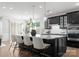 Kitchen island with marble countertops, black cabinets, pendant lighting, and modern bar stools at 2236 Prairie Rd, Concord, NC 28027