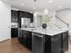 Modern kitchen with stainless steel appliances, dark cabinets, granite counters, and an eat-in island at 2236 Prairie Rd, Concord, NC 28027