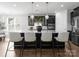 Stylish kitchen with black cabinetry, marble counters, pendant lights, and seating at the island at 2236 Prairie Rd, Concord, NC 28027