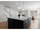 Gourmet kitchen island with granite countertop, dark cabinets, and pendant lighting at 2236 Prairie Rd, Concord, NC 28027