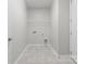 Functional laundry room with tile flooring, utility connections and open shelving for storage at 2236 Prairie Rd, Concord, NC 28027