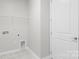 Clean and simple laundry room with tile flooring, utility connections and plenty of storage at 2236 Prairie Rd, Concord, NC 28027