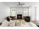 Bright living room features a fireplace, modern ceiling fan and is filled with natural light at 2236 Prairie Rd, Concord, NC 28027