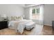 Comfortable main bedroom featuring carpet floors, a large window, and a stylish seating bench at 2236 Prairie Rd, Concord, NC 28027