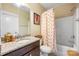 Well-lit bathroom with a granite countertop vanity, shower-tub combo, and neutral wall color at 2313 Blueberry St, Belmont, NC 28012