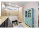Bright bathroom with tiled shower, stylish vanity, modern fixtures, and a turquoise cabinet for linens or toiletries at 2313 Blueberry St, Belmont, NC 28012