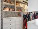 Organized walk-in closet with custom shelving, drawers, and hanging space, showcasing a stylish black and white wallpaper at 2313 Blueberry St, Belmont, NC 28012