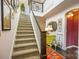 Inviting foyer showcasing staircase, colorful decor, hardwood floors, and a curated gallery wall for a welcoming entrance at 2313 Blueberry St, Belmont, NC 28012