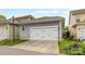 Two car garage with a gray exterior and a well-maintained concrete driveway at 2313 Blueberry St, Belmont, NC 28012