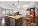 Open-concept kitchen, living, and dining area with an eat-in island at 2313 Blueberry St, Belmont, NC 28012