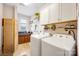 Well-equipped laundry room with washer, dryer, cabinetry, folding area, window, and room to accomplish your cleaning tasks at 2313 Blueberry St, Belmont, NC 28012