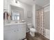 Bright bathroom boasts a spacious vanity, modern fixtures, and a shower with a patterned curtain at 240 Briana Marie Way, Indian Trail, NC 28079
