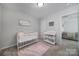 Cozy Bedroom featuring a white crib, changing table, and stylish decor, perfect for a baby's room at 240 Briana Marie Way, Indian Trail, NC 28079