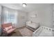 Adorable Bedroom featuring a rocking chair, crib, soft rug and a cozy atmosphere at 240 Briana Marie Way, Indian Trail, NC 28079