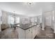 Stylish kitchen island with stainless steel appliances and open view to the living spaces at 240 Briana Marie Way, Indian Trail, NC 28079