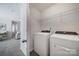 Well-equipped laundry room with a new washer, dryer, and overhead shelving for convenient storage at 240 Briana Marie Way, Indian Trail, NC 28079