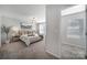 Serene bedroom showcases a comfortable bed, stylish lamps, and soothing color palette promoting relaxation at 240 Briana Marie Way, Indian Trail, NC 28079