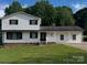 Charming two-story home with black shutters, white siding, and a well-maintained front lawn at 2412 Elizabeth Ave, Shelby, NC 28150