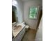 Bathroom features white cabinets, a pink sink, and a window providing natural light at 2412 Elizabeth Ave, Staley, NC 28150