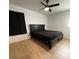 Bedroom with wood-look floors, ceiling fan, and comfortable bed. Blackout curtains at 2412 Elizabeth Ave, Staley, NC 28150