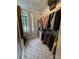 Organized walk-in closet with patterned carpet and natural light from a window at 2412 Elizabeth Ave, Staley, NC 28150