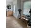 Welcoming entryway featuring laminate flooring, a decorative mirror, and natural lighting at 2412 Elizabeth Ave, Staley, NC 28150