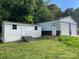 Exterior view of a shed and detached garage with a metal roof and siding at 2412 Elizabeth Ave, Staley, NC 28150