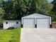 Exterior view of a shed and detached garage with a metal roof and concrete driveway at 2412 Elizabeth Ave, Staley, NC 28150