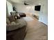Comfortable living room featuring a plush sectional sofa, light-colored floors and a mounted TV at 2412 Elizabeth Ave, Staley, NC 28150