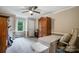 Neutral bedroom with a ceiling fan, carpet, and a large wooden armoire at 2434 Olewoods Ct, Rock Hill, SC 29732