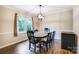 Light-filled dining room with elegant light fixture and view to the outdoor greenery at 2434 Olewoods Ct, Rock Hill, SC 29732