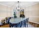 Charming dining room features unique chandelier and flows into the kitchen and living room at 2434 Olewoods Ct, Rock Hill, SC 29732