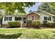Attractive brick and siding home with a welcoming front porch and manicured shrubs at 2434 Olewoods Ct, Rock Hill, SC 29732