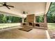 Covered brick patio with a stone fireplace and ceiling fans for added comfort at 2434 Olewoods Ct, Rock Hill, SC 29732