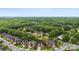 Aerial view of a residential community surrounded by a lush green forest at 2563 Firethorn Ct, Gastonia, NC 28056