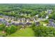 Aerial view of a quaint neighborhood with well-kept lawns near a dense green forest at 2563 Firethorn Ct, Gastonia, NC 28056