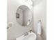 Modern bathroom vanity with stylish round mirror and updated fixtures at 2563 Firethorn Ct, Gastonia, NC 28056