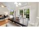 Chic dining room with a vaulted ceiling and an adjacent fireplace and living area at 2563 Firethorn Ct, Gastonia, NC 28056