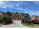 Charming two-story brick home with well-manicured lawn, a two-car garage, and landscaped front yard at 2563 Firethorn Ct, Gastonia, NC 28056