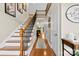 Inviting foyer with hardwood floors, staircase, and a glimpse of the living room with fireplace at 2563 Firethorn Ct, Gastonia, NC 28056