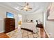 Main bedroom features a tray ceiling, hardwood floors, and an adjacent en-suite bathroom at 2563 Firethorn Ct, Gastonia, NC 28056