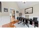 Office featuring hardwood floors, stylish desk with decor, and a view into the adjacent kitchen at 2563 Firethorn Ct, Gastonia, NC 28056