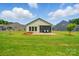 Lush backyard featuring a patio, screened porch, and manicured lawn with tree at 258 Cherrytree Dr, Fort Mill, SC 29715