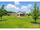 Lush backyard with patio, screened in porch, mature lawn, and manicured landscaping at 258 Cherrytree Dr, Fort Mill, SC 29715