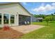 Backyard patio with screened porch, brick pavers, and a neatly manicured lawn at 258 Cherrytree Dr, Fort Mill, SC 29715