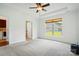 Large bedroom features carpet, a ceiling fan, a window and an entrance to an ensuite bathroom at 258 Cherrytree Dr, Fort Mill, SC 29715