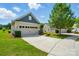 Street view featuring a well-kept lawn, a spacious two-car garage and mature landscaping at 258 Cherrytree Dr, Fort Mill, SC 29715