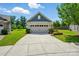 Charming home exterior showcasing a well-maintained lawn and a convenient two-car garage at 258 Cherrytree Dr, Fort Mill, SC 29715