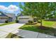 Beautiful home exterior featuring a well-manicured lawn, mature tree, and a spacious two-car garage at 258 Cherrytree Dr, Fort Mill, SC 29715